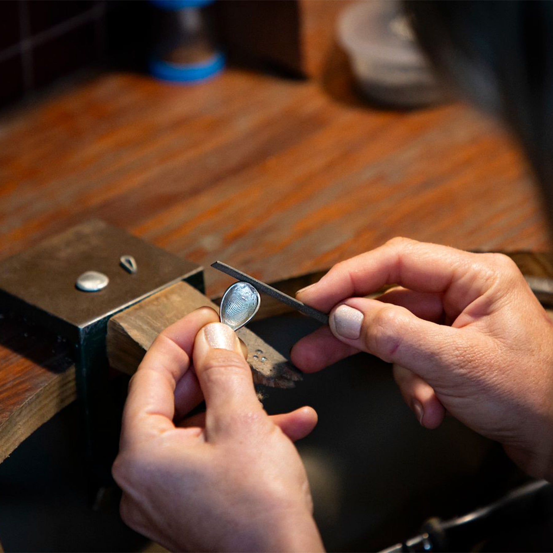 Hand-finishing a fingerprint impression mould in jewellery workshop