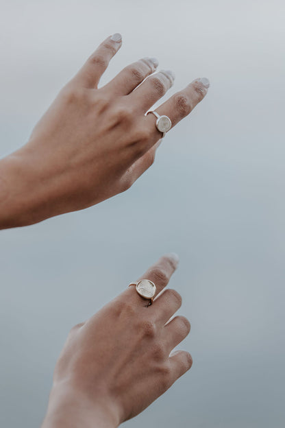 A close-up of a lady's hands, with an impression ring on each index finger.