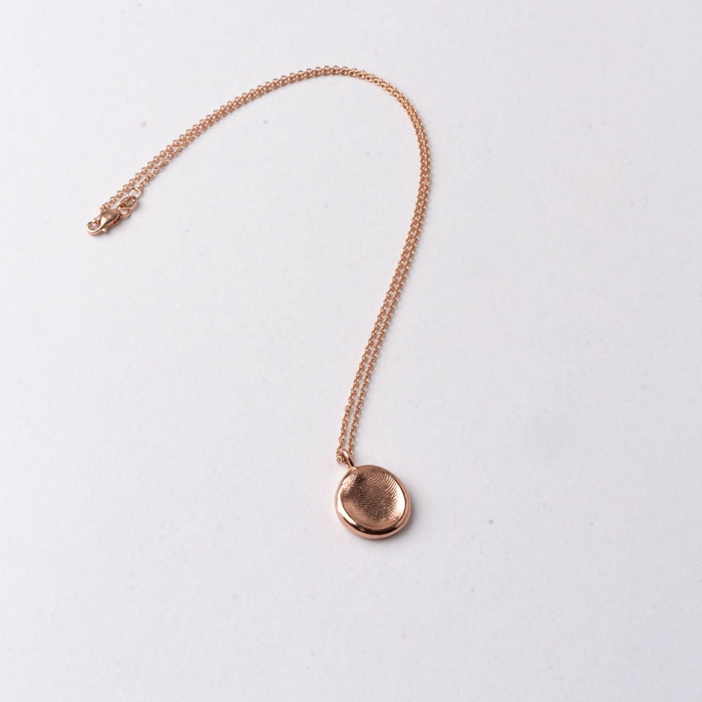 A ROHO Heritage Jewellery impression pendant on a chain, in 9ct rose gold, displayed on a clean white background. 